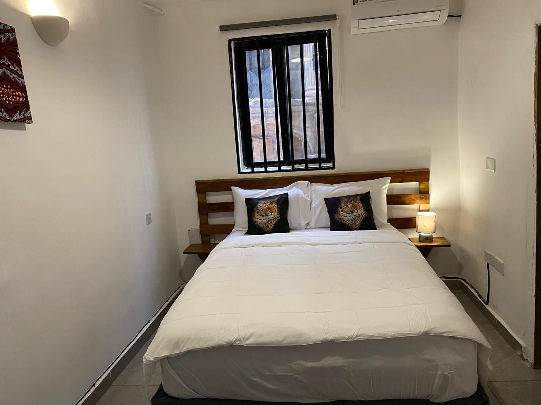 Guest room at Belvoir with a double bed, bedside lamp and air conditioning