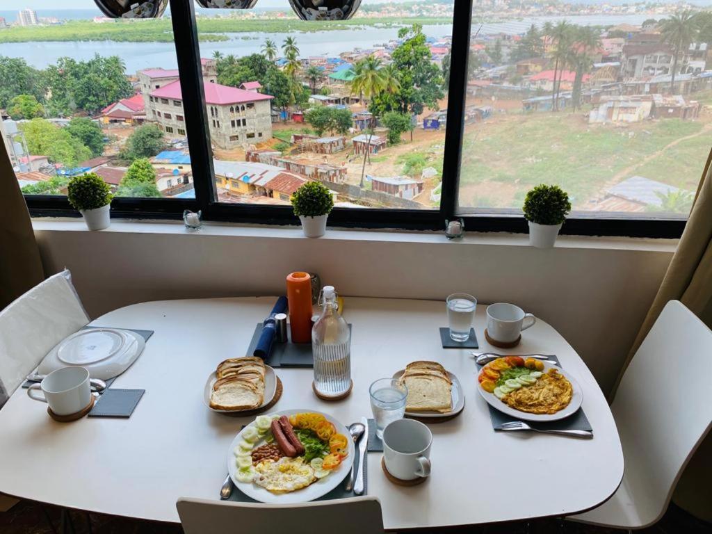 Breakfast laid out at a window table overlooking Freetown