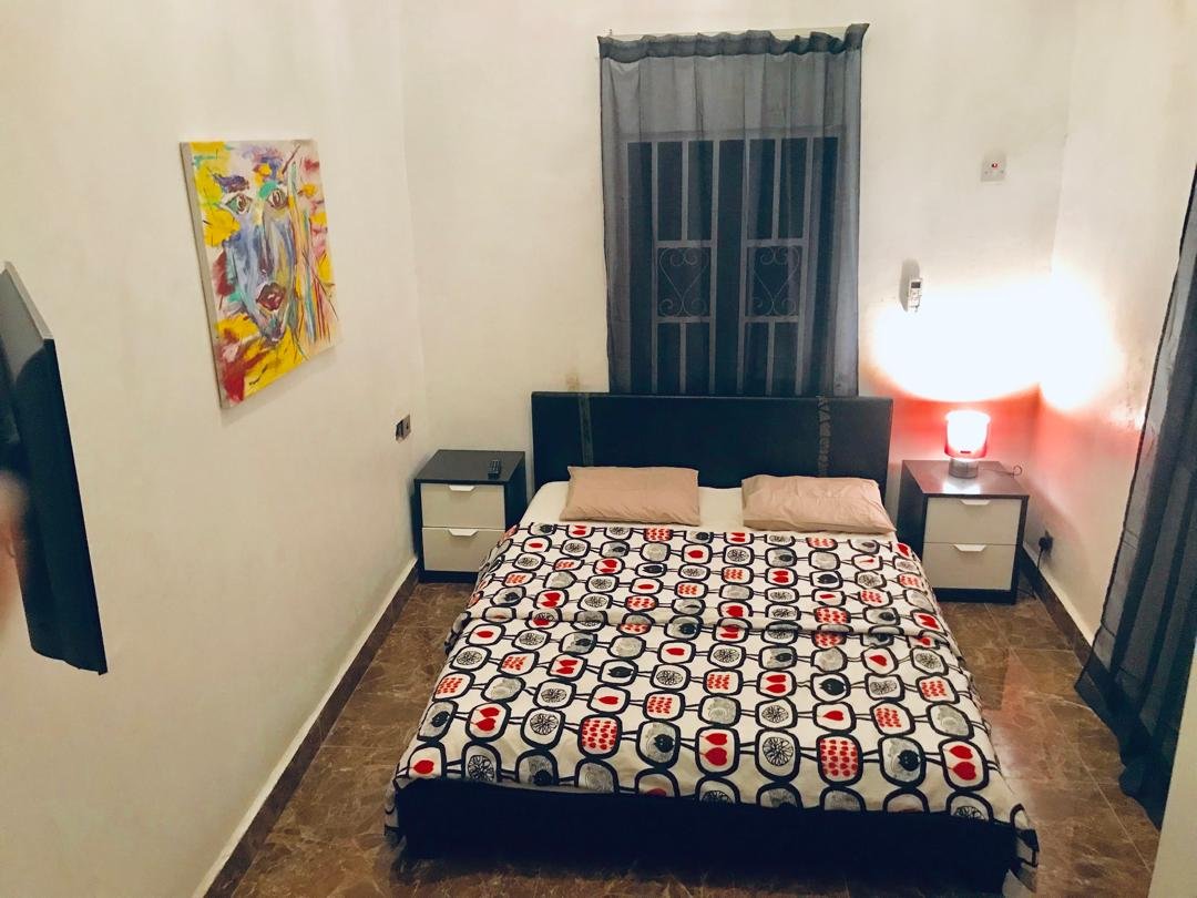 Ground floor bedroom with patterned bedding