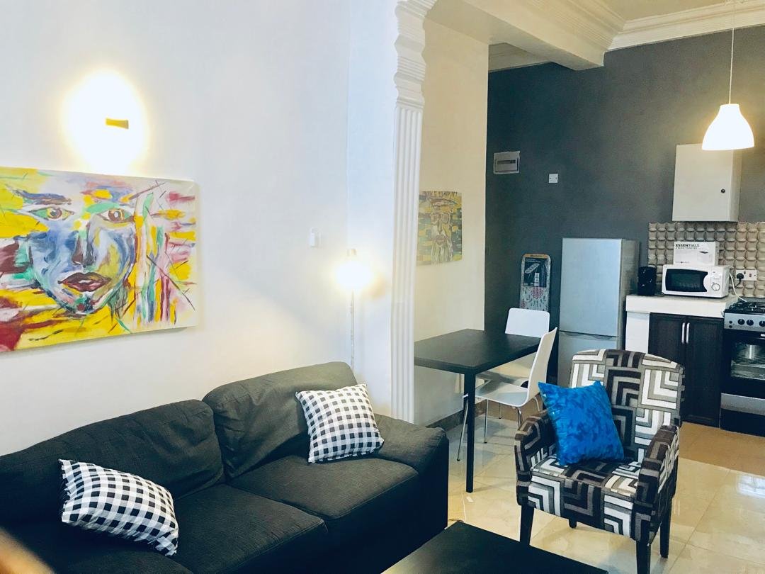 Ground floor lounge with sofa and armchair