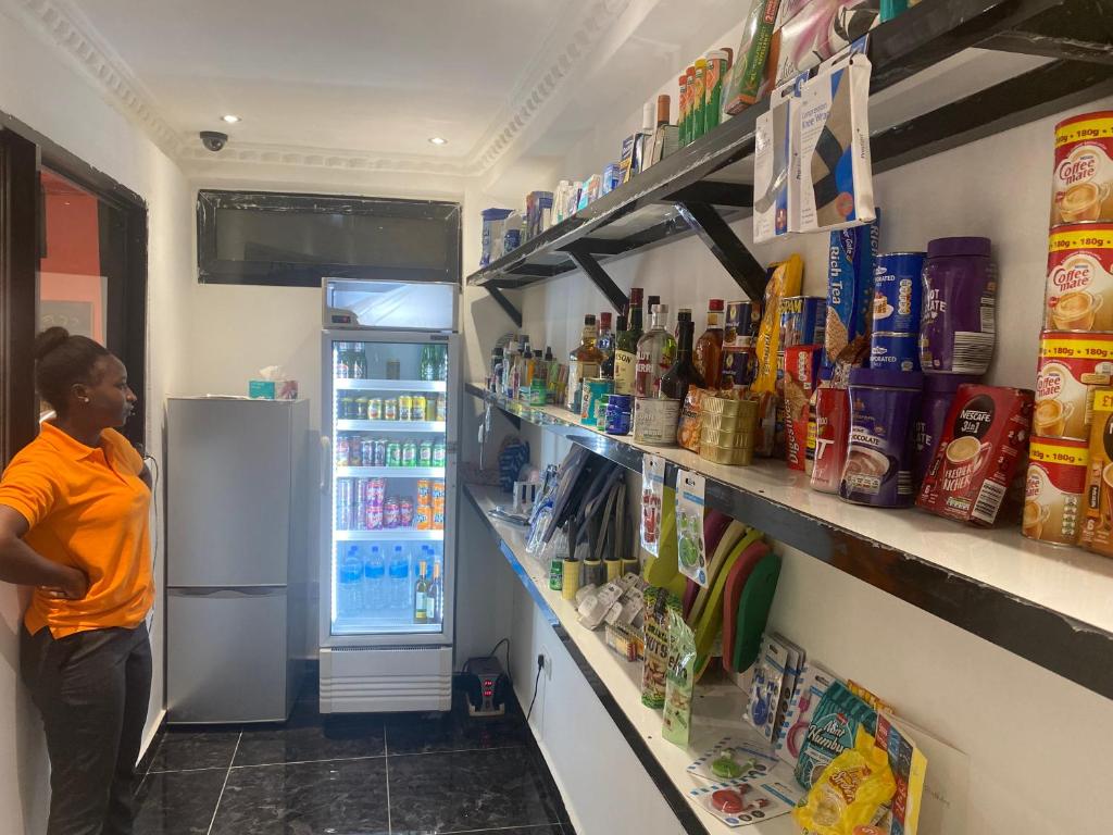 Staff member at the stocked shelves of the on-site mini mart