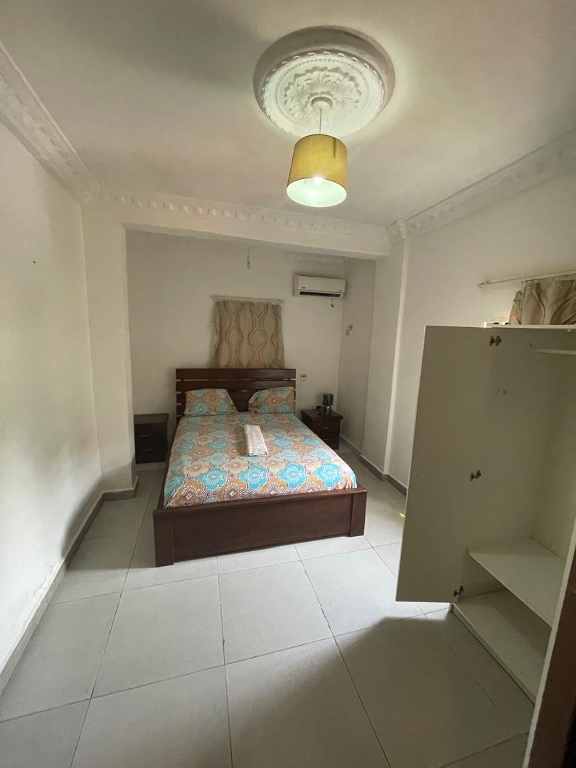 Apartment bedroom with wardrobe and patterned bedding
