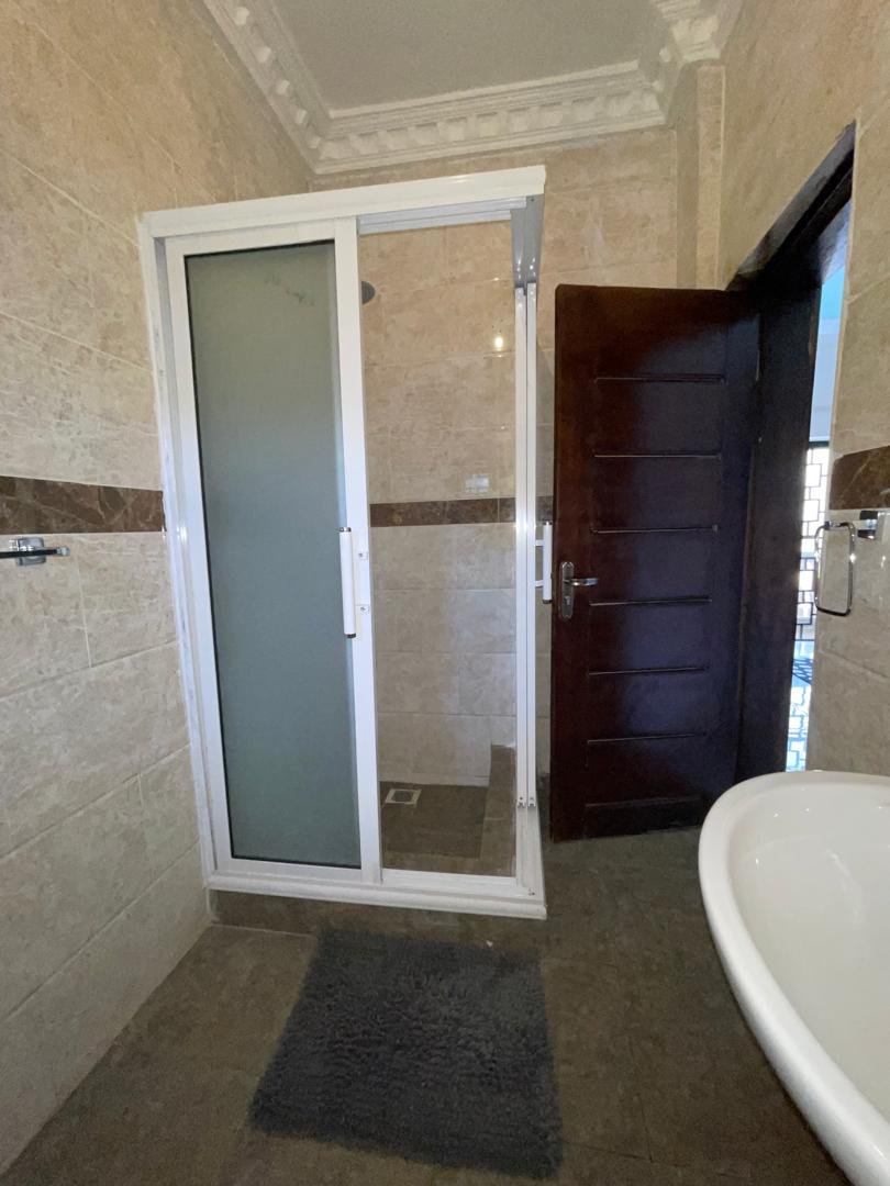 Apartment bathroom with glass shower cabin