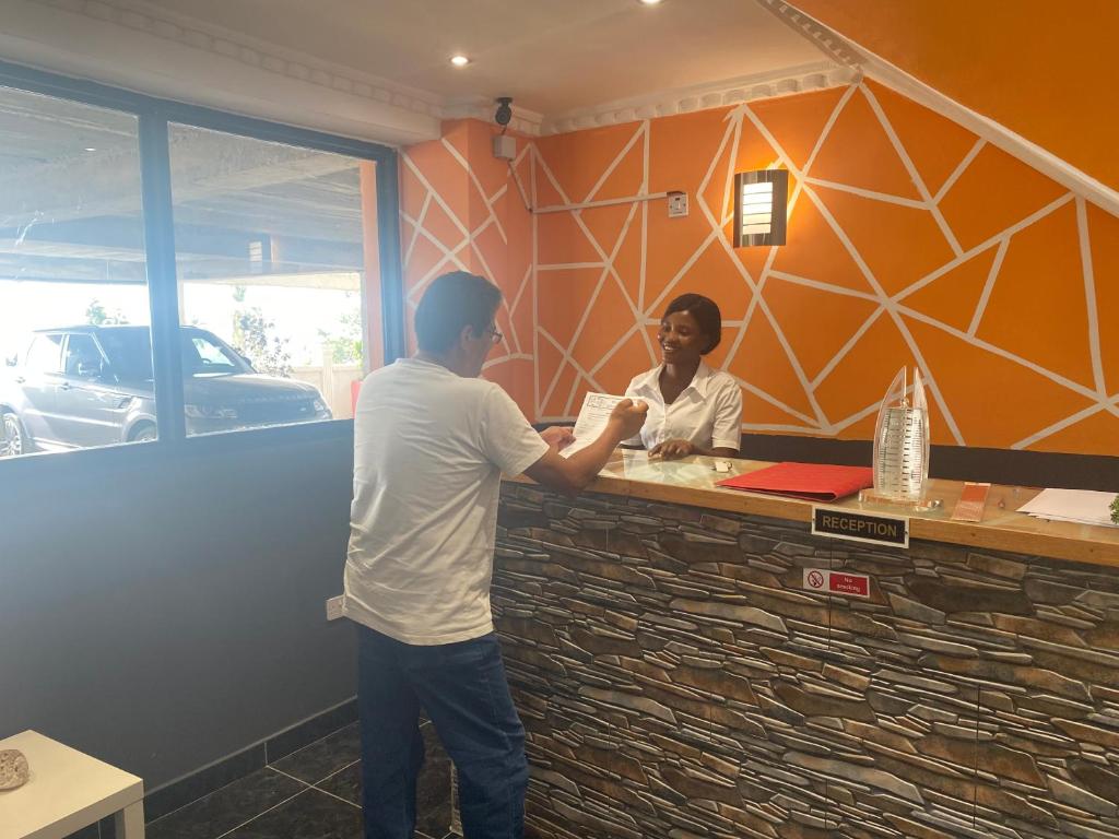 A guest being welcomed at the Belvoir reception desk