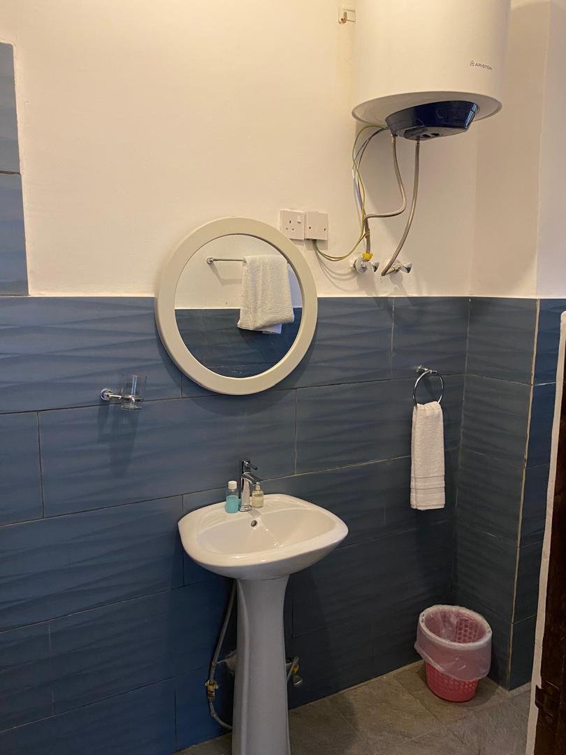 En-suite basin, mirror and water heater