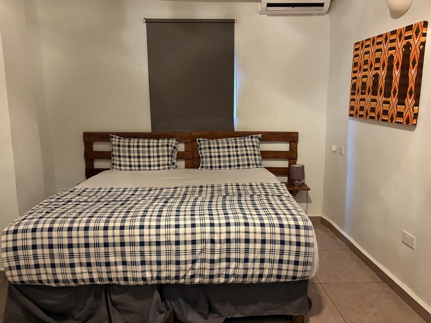 Deluxe standard room with king bed and African art
