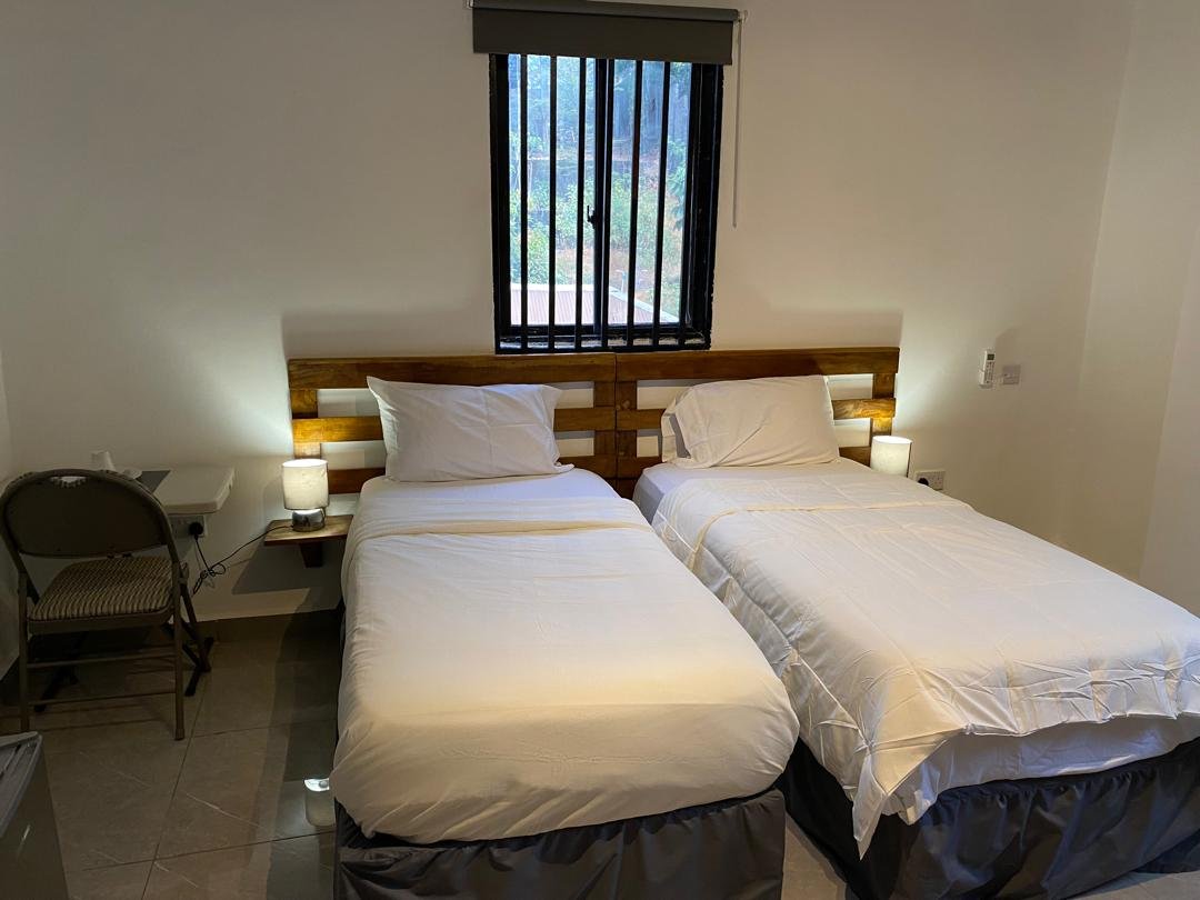 Twin room with work desk beside the window