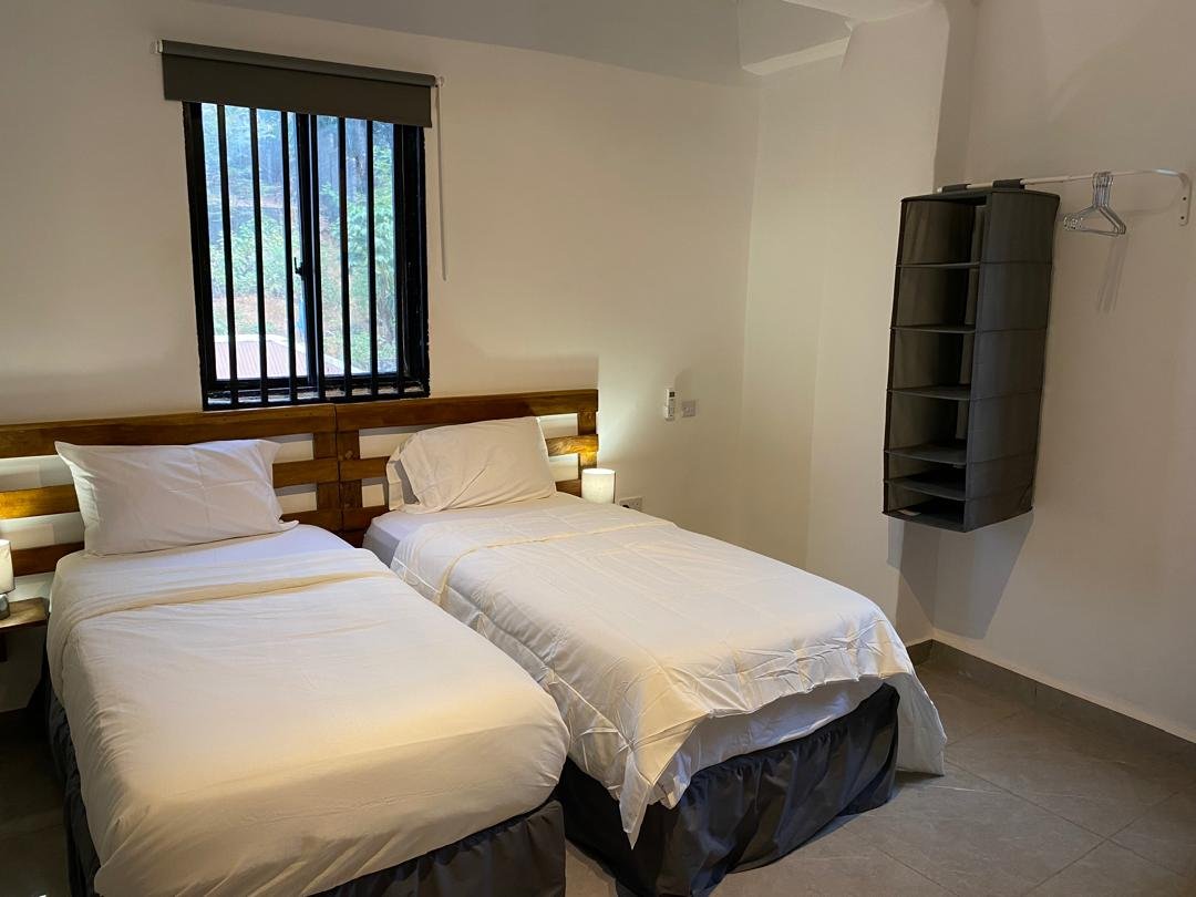 Twin room with wardrobe and hanging rail