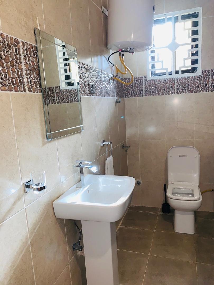 Two-bedroom apartment bathroom with basin, mirror and WC
