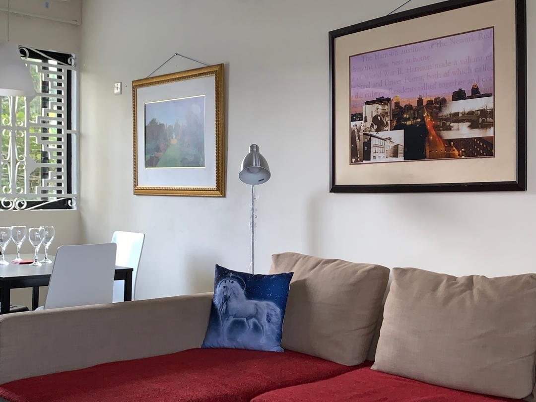 Two-bedroom apartment lounge with framed art and window